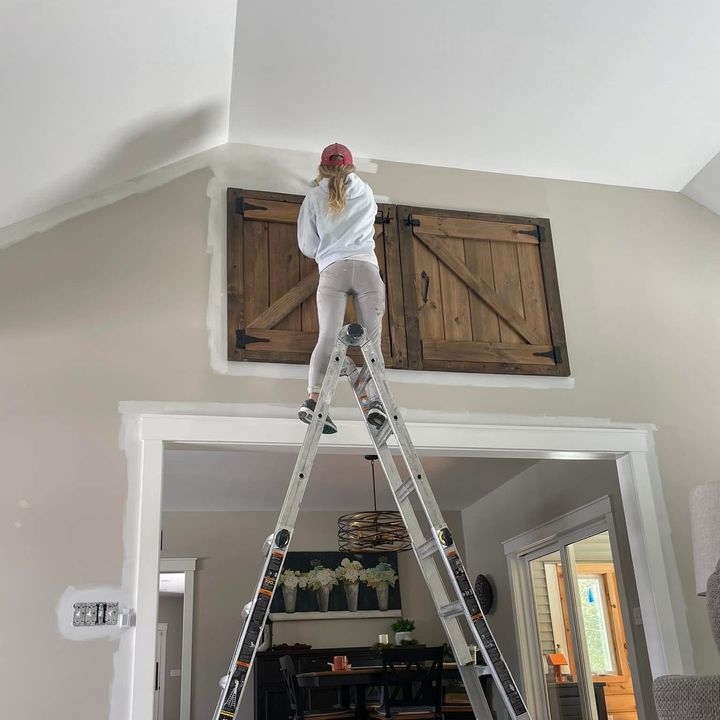 Roll With It painter working from a ladder