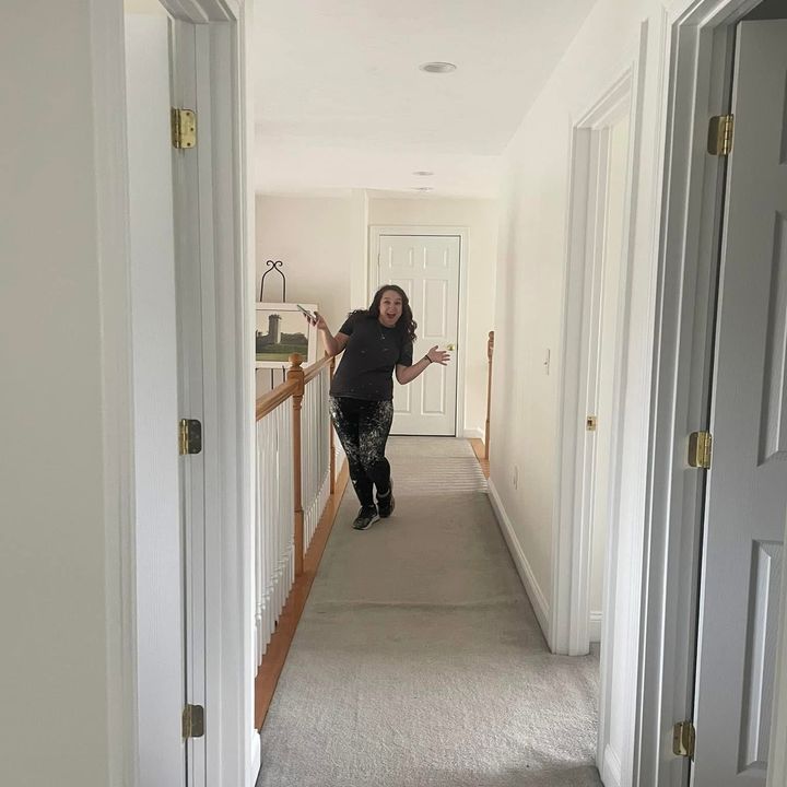Roll With It painter checking a finished hallway