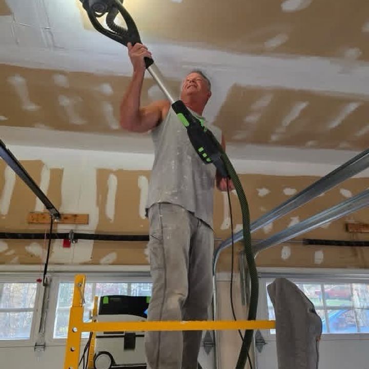 Roll With It painter sanding a surface