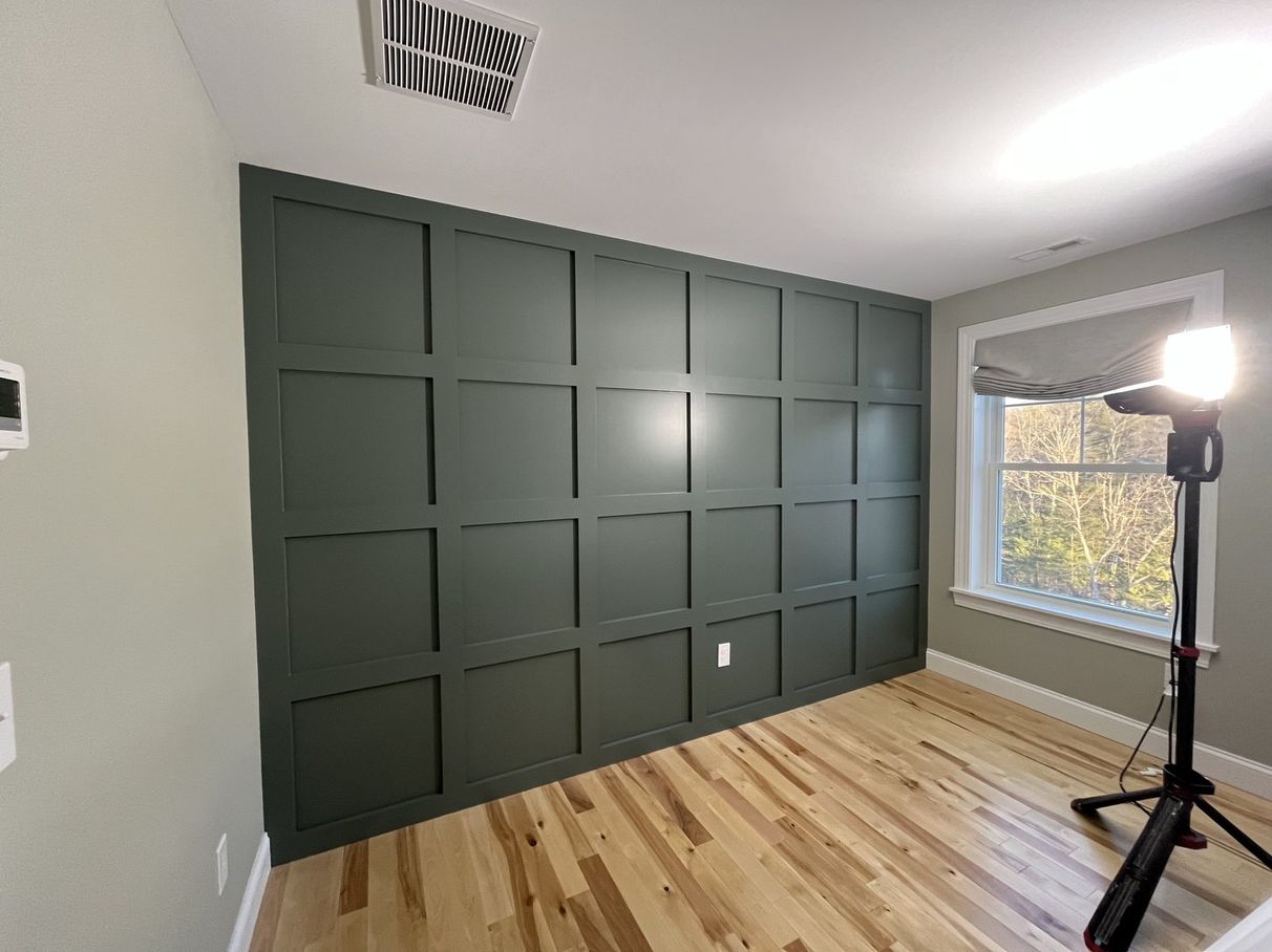 Painted built-in wall with dark green paneling