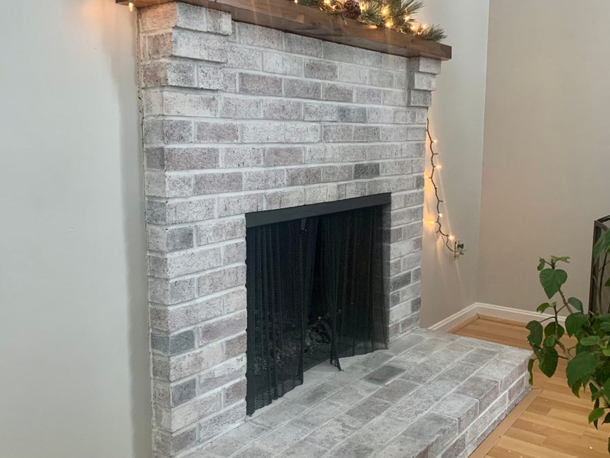 Whitewashed fireplace with a dark surround