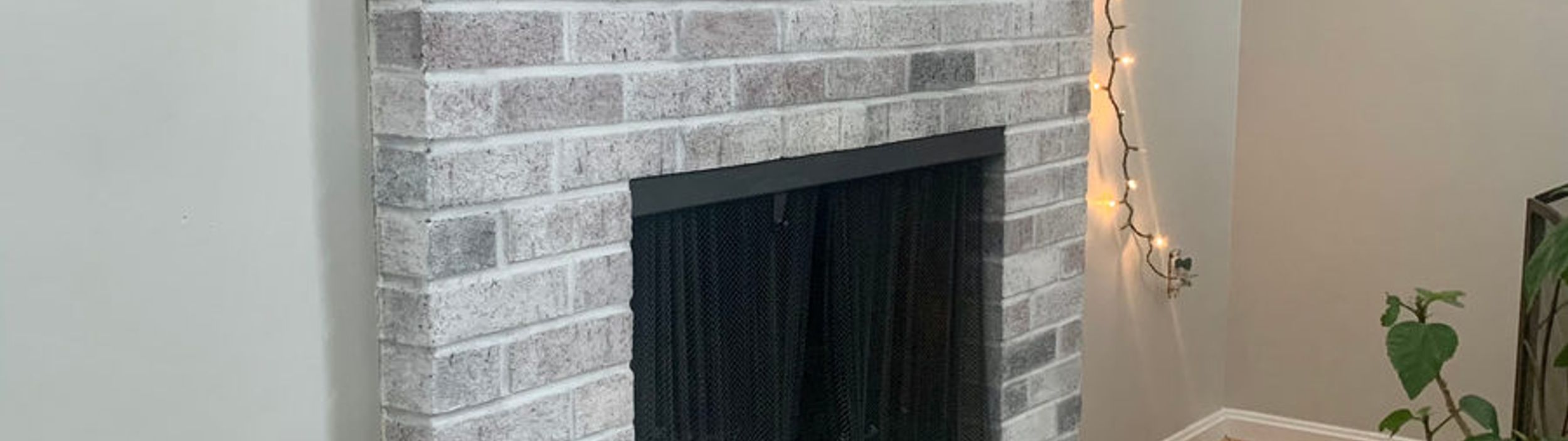 Whitewashed fireplace with a painted mantel