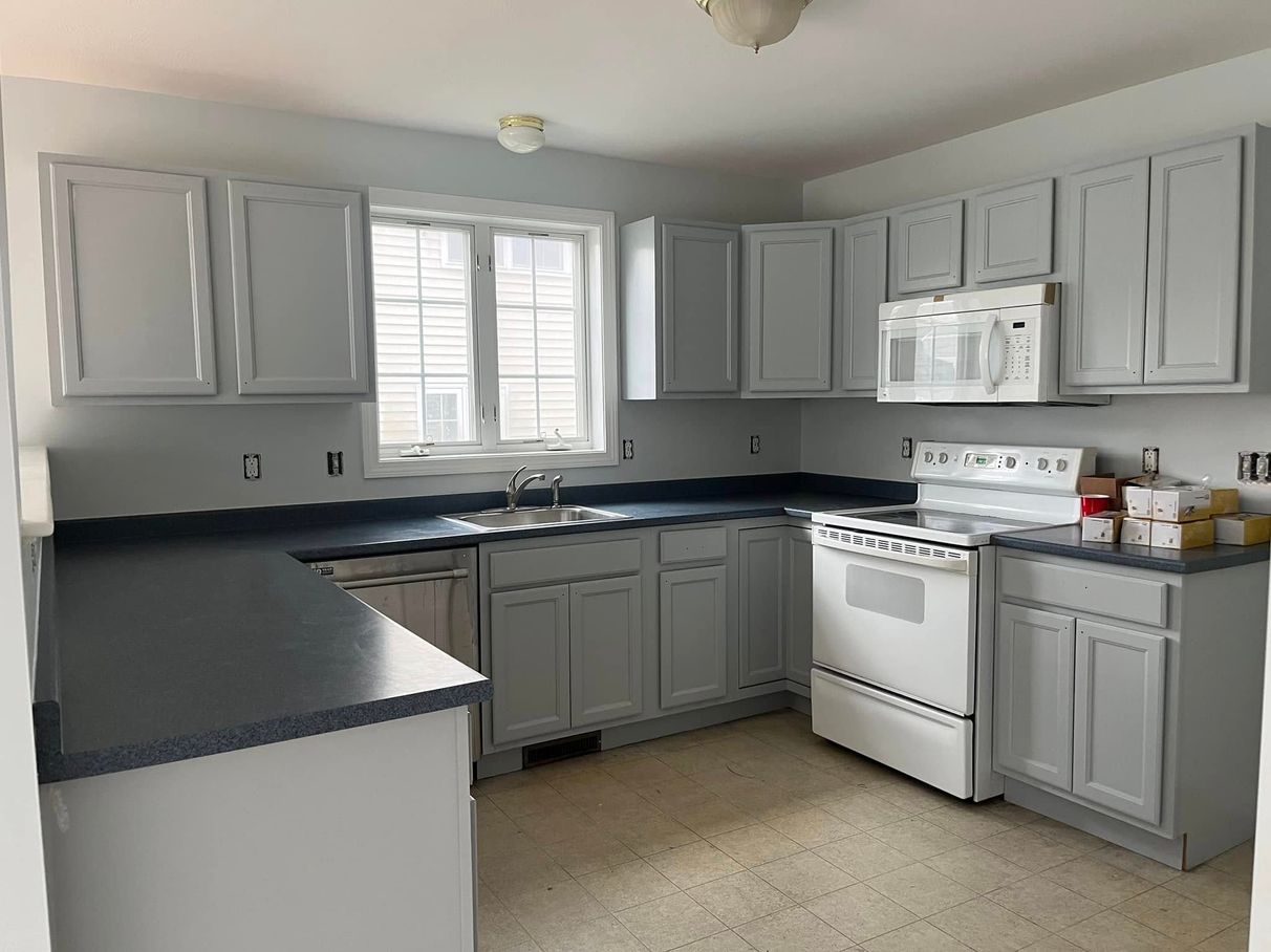Painted kitchen cabinets after a Roll With It project