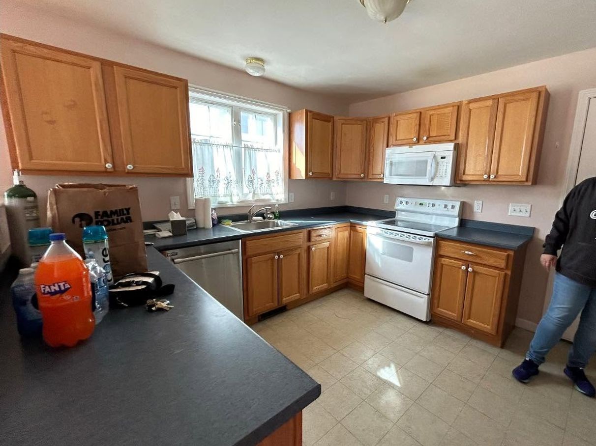 Wood kitchen cabinets before a Roll With It project