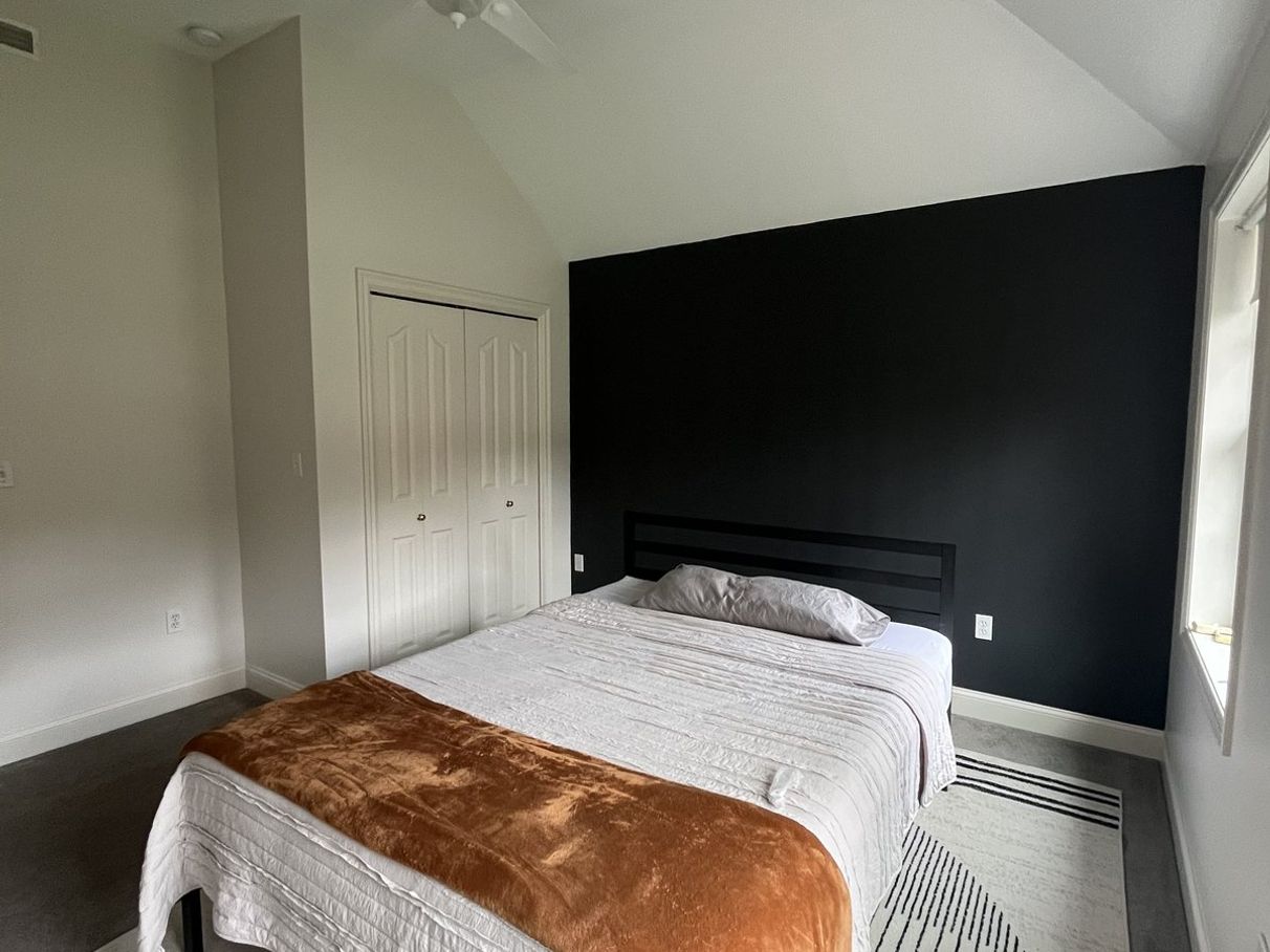 Interior bedroom with a dark accent wall