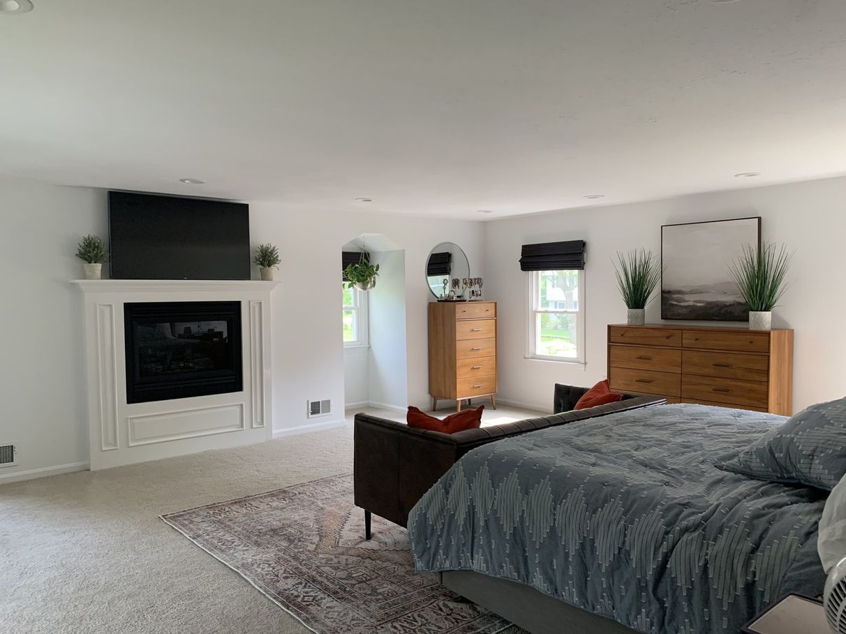 Bedroom with a painted fireplace wall